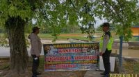 Bhabinkamtibmas Polsek Belitang II Polres OKU Timur Polda Sumsel Memasang Sanduk Himbauan Jalur Rawan Banjir